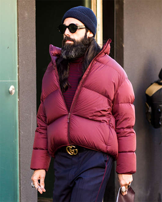 A street-style image of a man in a puffer jacket