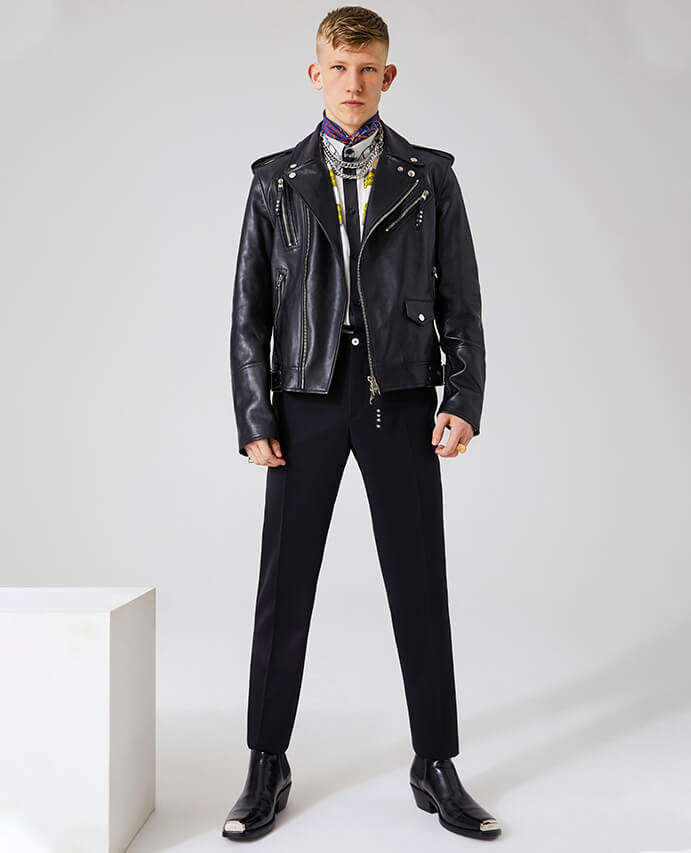 Alexander McQueen leather biker jacket worn with Versace printed shirt