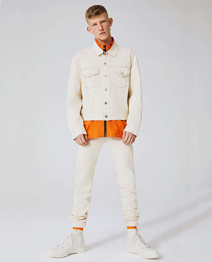 Helmut Lang denim jacket and jeans worn with orange Stussy jacket and Heron Preston socks