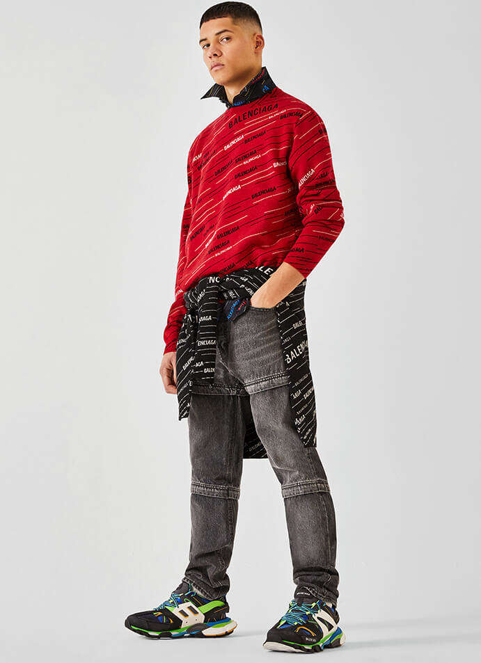 The model is wearing a Balenciaga jumper and jeans.