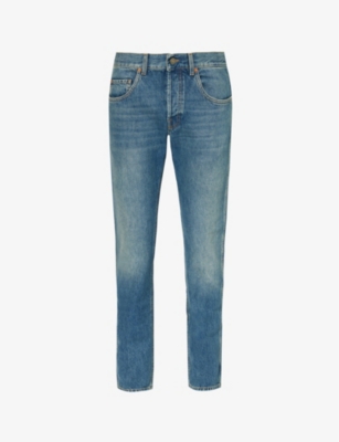 GUCCI: Brand-patch faded-wash mid-rise tapered-leg jeans