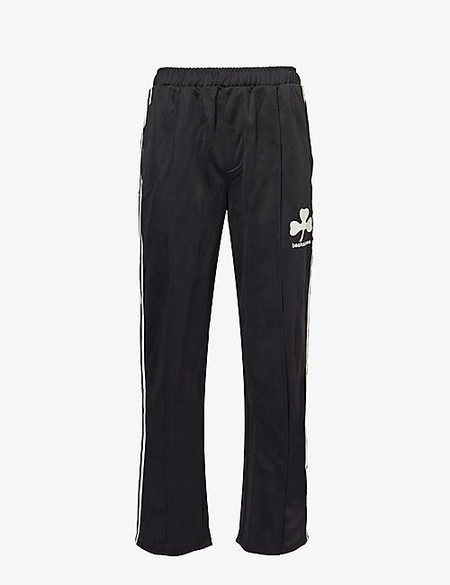 BASKETCASE: Lucky branded-print woven trousers