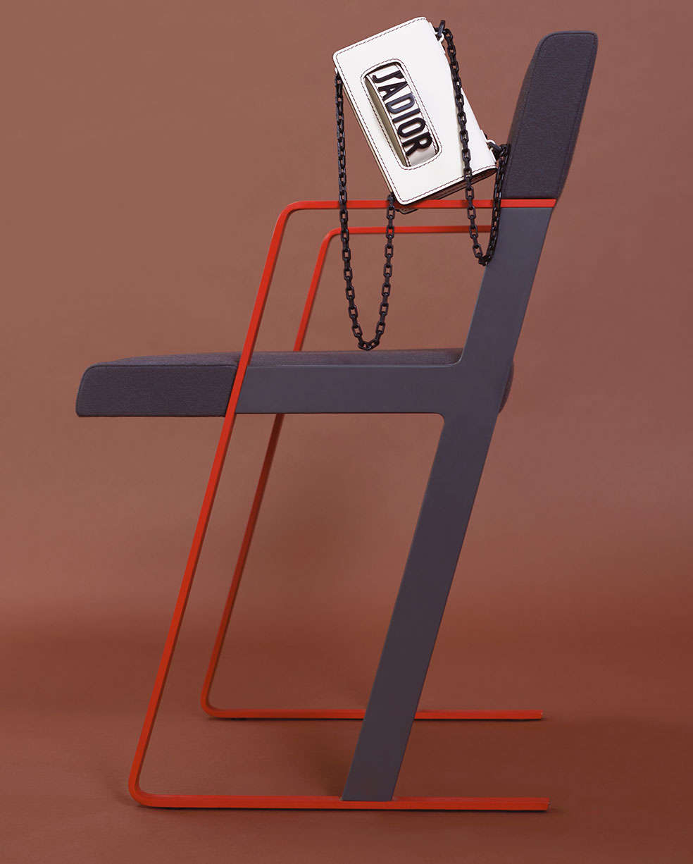A Dior bag on a chair