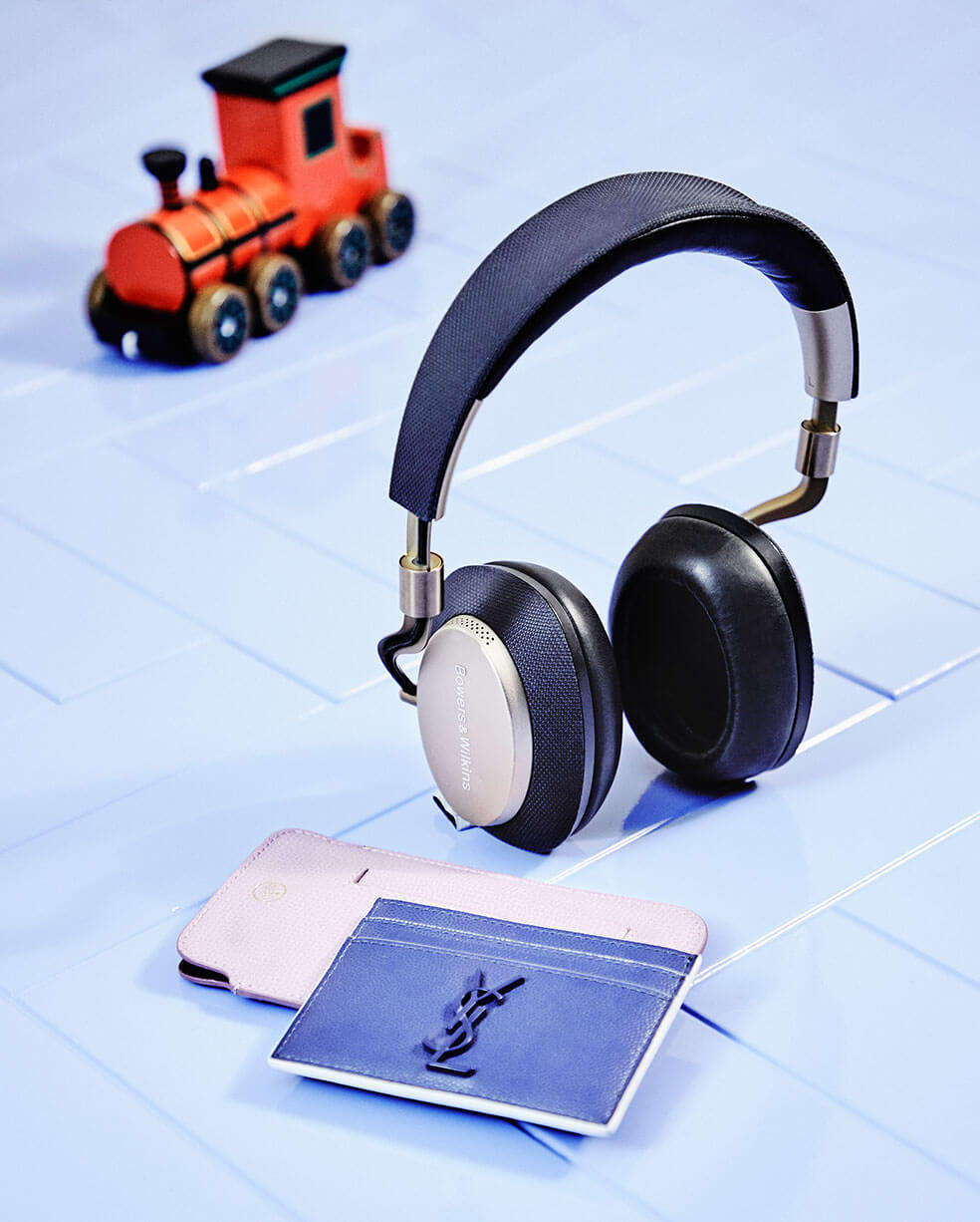 A pair of headphones and leather card and phone holder