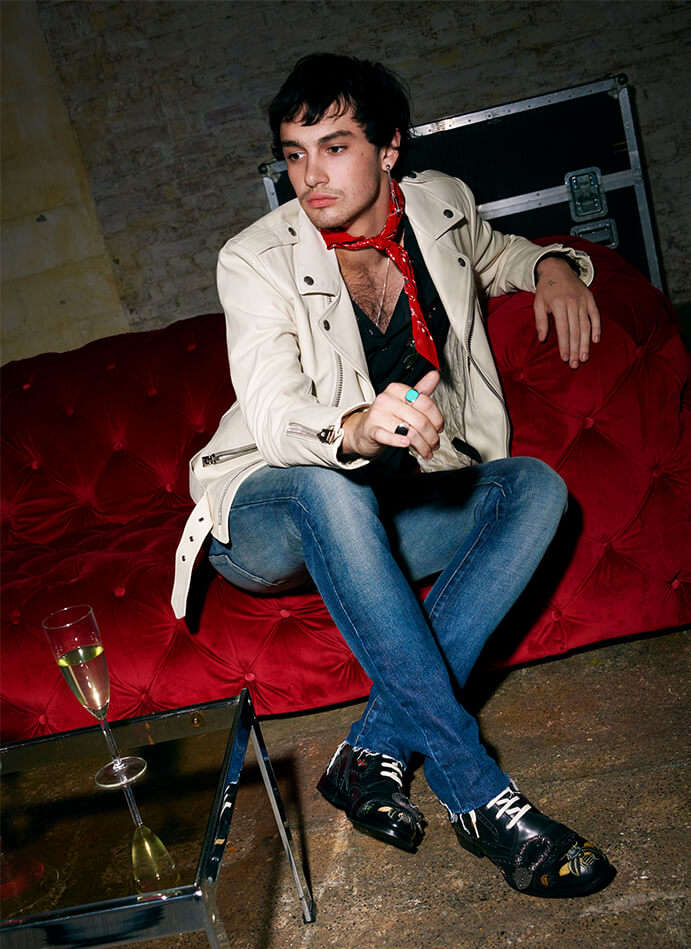 Model wearing Tom Ford leather jacket and Alexander McQueen shirt with Saint Laurent Jeans and Gucci boots. 