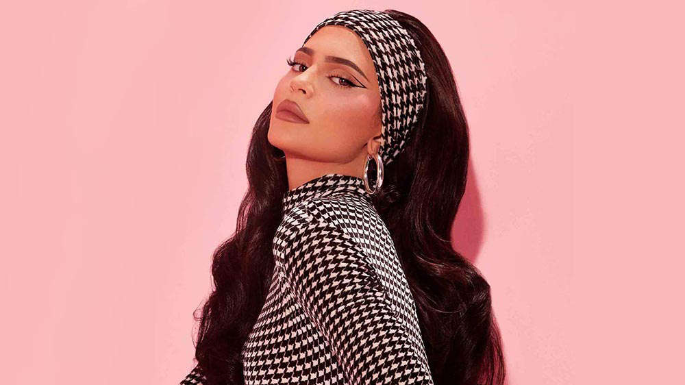 Kylie Jenner wears nude colored makeup as she models a headscarf