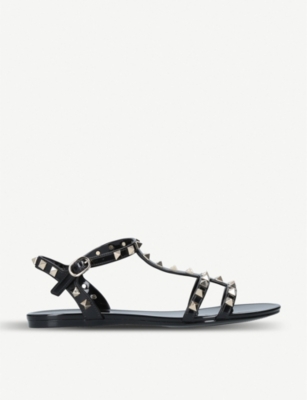 VALENTINO GARAVANI: Rockstud PVC gladiator sandals