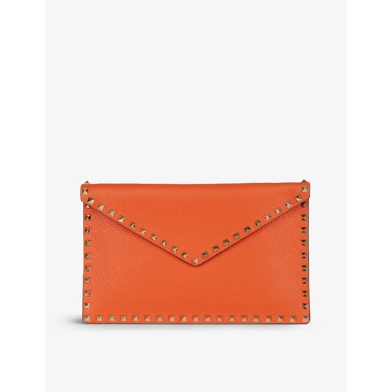 Valentino Garavani Rockstud Leather Envelope Pouch In Orange