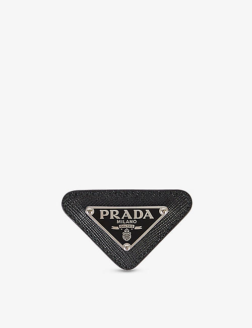 PRADA: Monogram triangular metal and leather pin