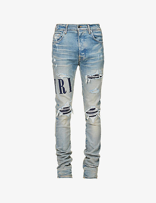 AMIRI: Brand-appliqué slim-fit tapered-leg stretch-cotton blend jeans