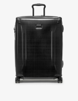 TUMI: Short Trip expandable four-wheel hard-shell packing suitcase 66cm