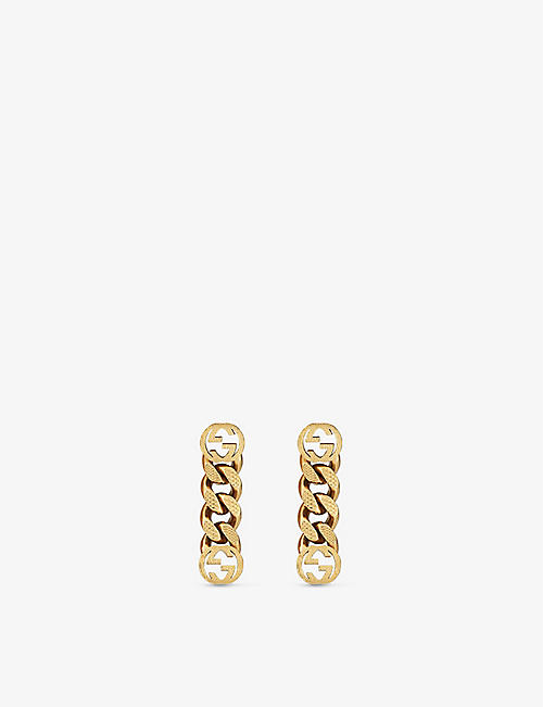 GUCCI: Interlocking G brass earrings