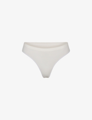skims-smoothing-mid-rise-stretch-woven-thong-selfridges