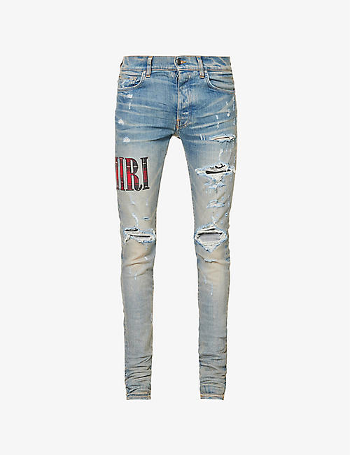 AMIRI: Core logo-appliqué tapered-leg mid-rise stretch-denim jeans