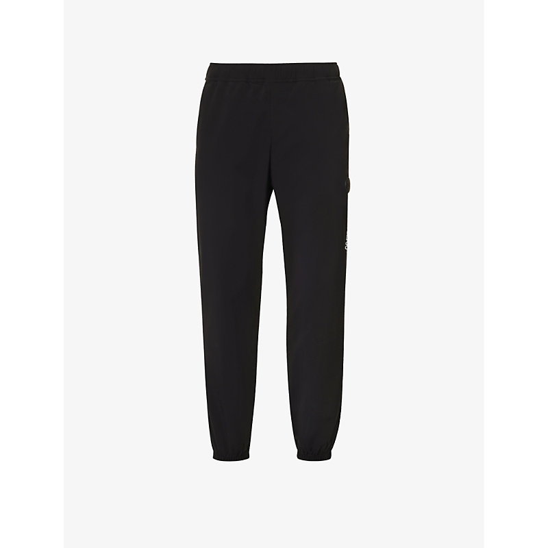 Aape Brand-patch Tapered-leg Stretch-woven Jogging Bottoms In Black