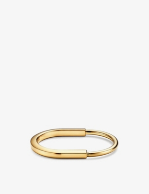 TIFFANY & CO - Lock 18ct yellow-gold bangle bracelet | Selfridges.com