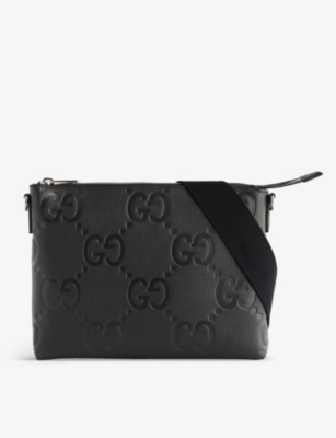 GUCCI Logo embossed leather cross body bag Selfridges