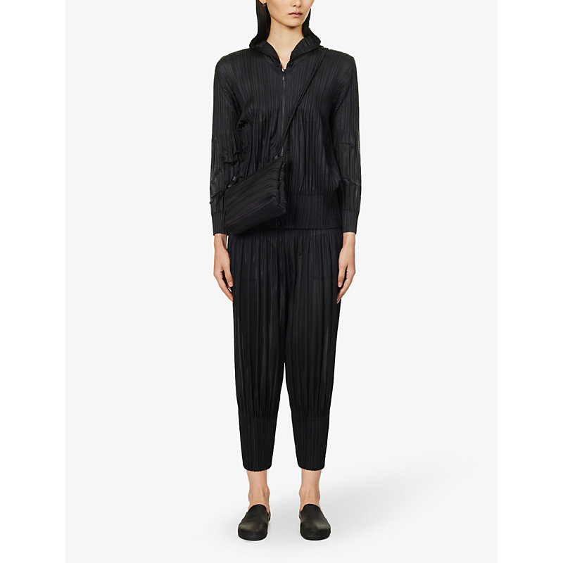 Shop Issey Miyake Pleated Tapered-leg Mid-rise Knitted Trousers In Black