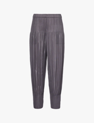 Shop Issey Miyake Pleated Tapered-leg Mid-rise Knitted Trousers In Gray