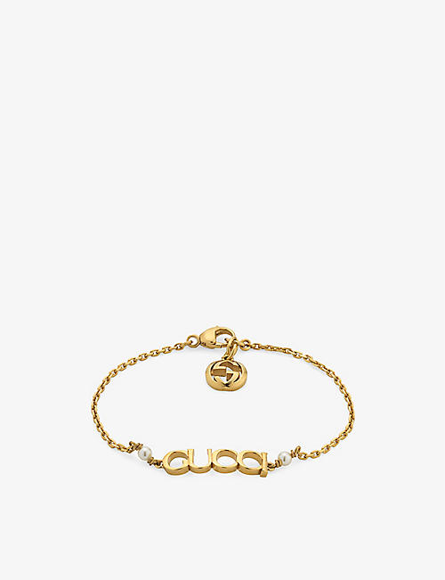 GUCCI: Logo-script glass-pearls gold-toned metal bracelet