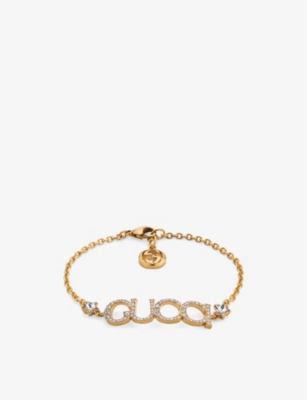 GUCCI: Logo-script embellished antique gold-toned metal bracelet