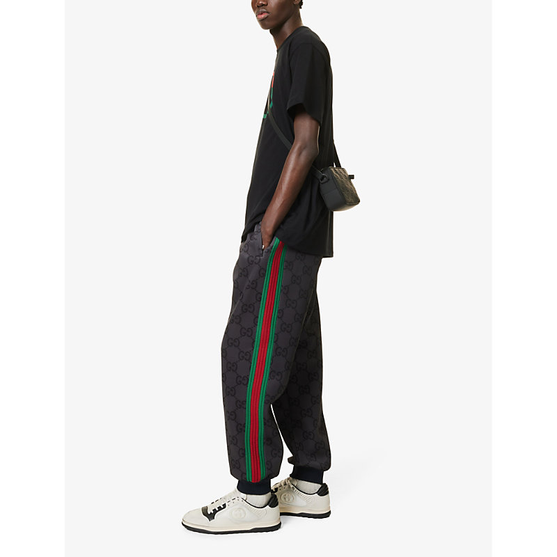 Shop Gucci Men's Grey/dark Grey/mc Monogram-patterned Tapered-leg Stretch-woven Jogging Bottoms