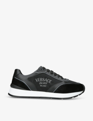 VERSACE Logo embellished leather low top trainers Selfridges