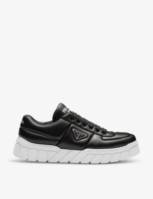 PRADA: Logo-plaque padded leather low-top trainers