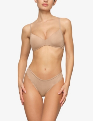 Shop Skims Wireless Form Logo-embossed Plunge Stretch-cotton Bra In Clay