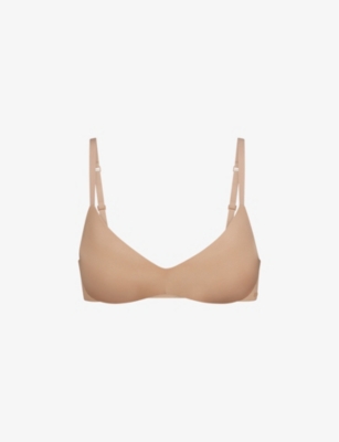 Shop Skims Wireless Form Logo-embossed Plunge Stretch-cotton Bra In Clay