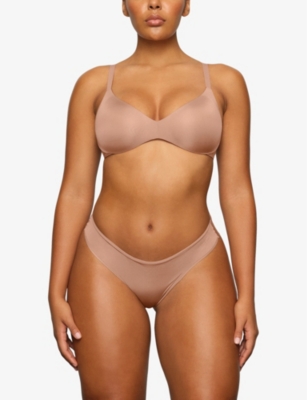 Shop Skims Wireless Form Logo-embossed Plunge Stretch-cotton Bra In Sienna