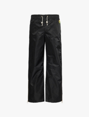 Mens Jw Anderson Brand-and-flower-patch zipped-cuffs wide-leg relaxed-fit shell trousers