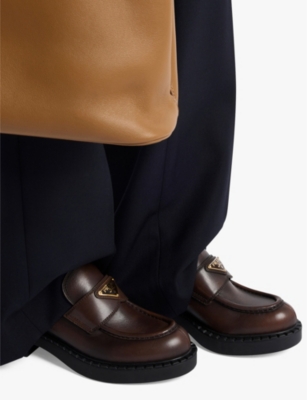PRADA: Chocolate logo-plaque brushed leather loafers
