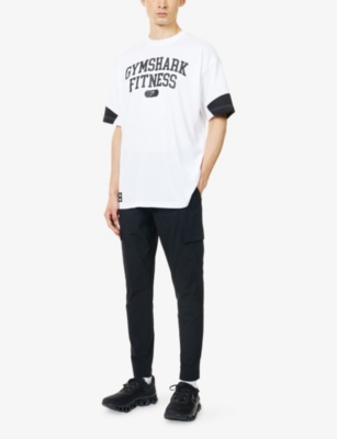 GYMSHARK: Varsity Oversized Woven T-Shirt