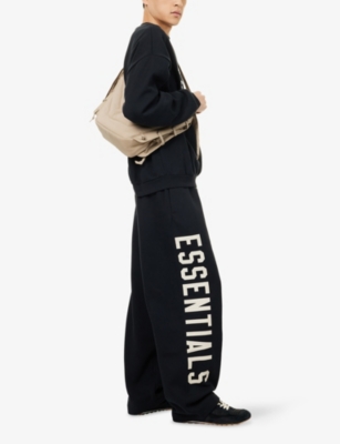 Essentials Mens Jet Black Brand-print Wide-leg Cotton-blend Jogging Bottoms In Black